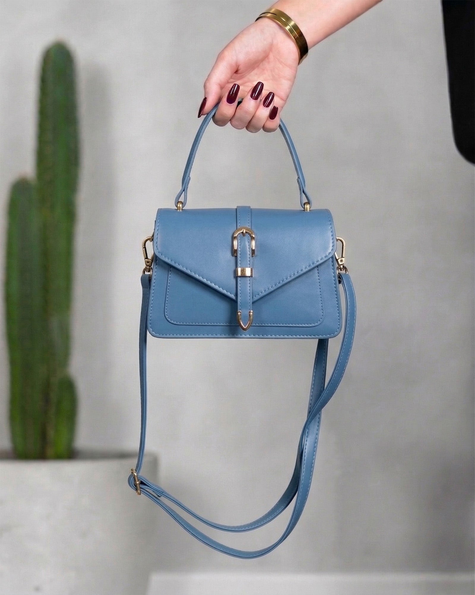 Cartera con solapa tipo sobre y hebilla central metalizada